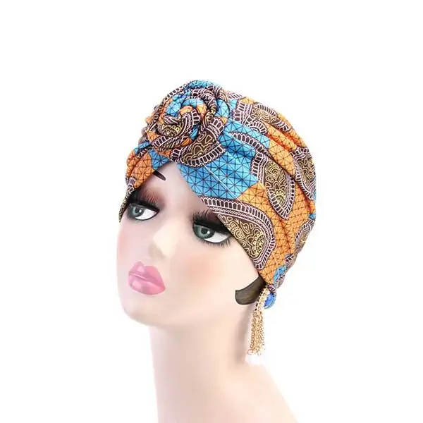 Bonnet femme style turban avec noeud a motif wax orange_2092. DIAYTAR SENEGAL - Là où Chaque Achat a du Sens. Explorez notre gamme et choisissez des produits qui racontent une histoire, votre histoire.