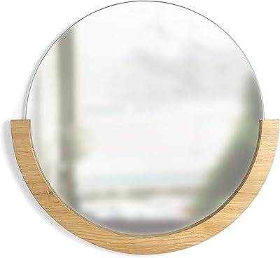 Miroir circulaire décoratif umbra avec cadre en bois sur la moitié inférieure